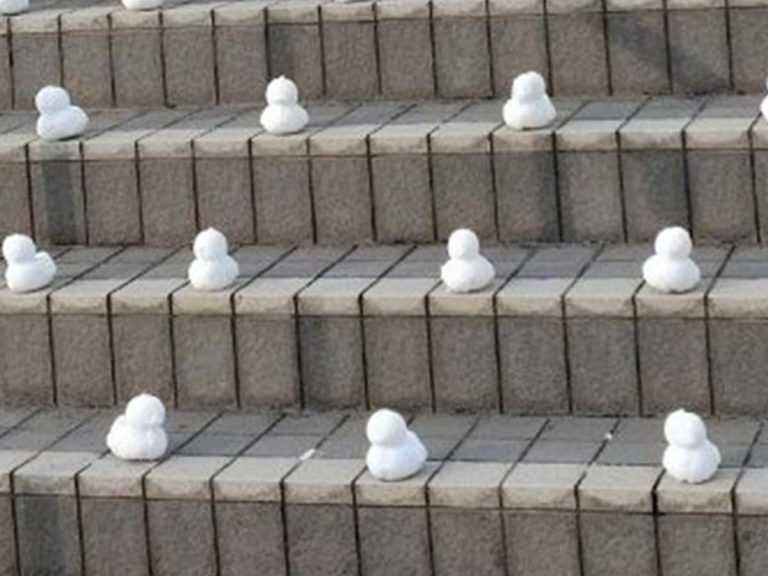 Miniature army of snowmen take over university stairway in Japan
