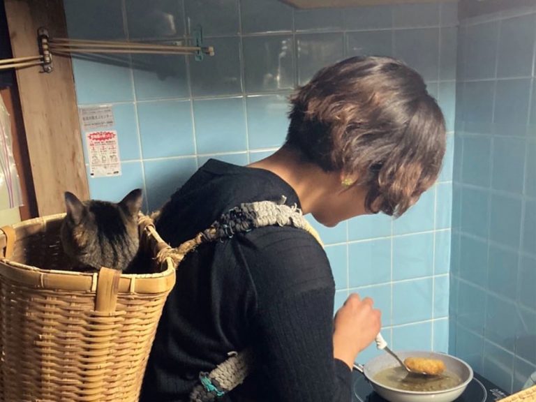 Owner whips up Demon Slayer solution to a super clingy cat while cooking