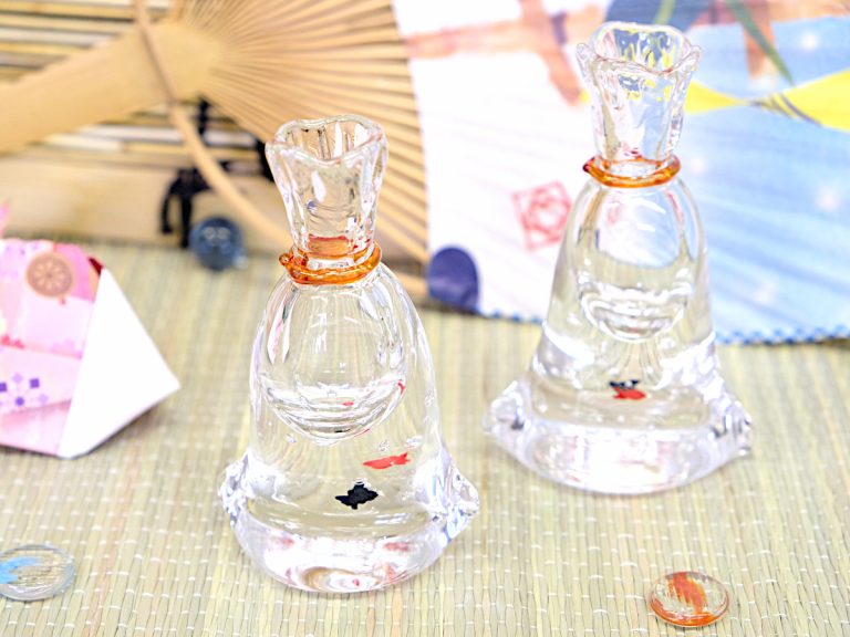 Fake goldfish swim in cute vases evoking a scene from Japanese summer festivals