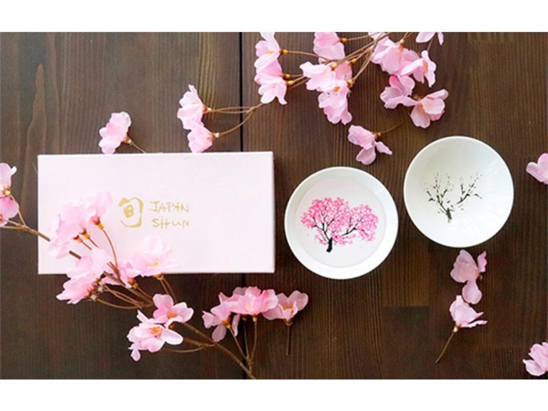 Elegant sakura Japanese sake cups bloom into colorful cherry blossoms with chilled sake