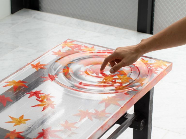 Artist creates gorgeous Japanese autumn leaves fallen on water table with rippling effect