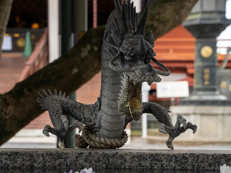 Dragon god seemingly stunned by sudden temple decorations in Japan