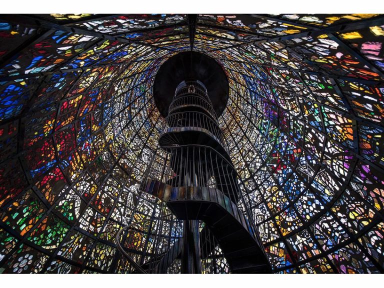 Japanese photographer captures breathtaking images of stained glass spiral staircase