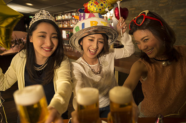 Women are toast with beer birthday of friend