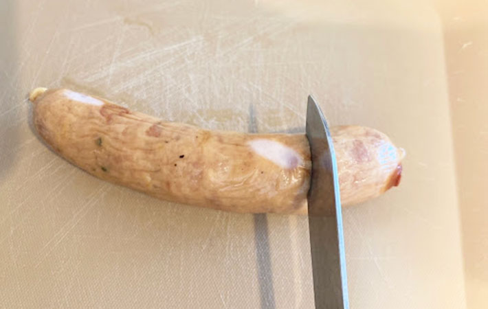 『SOBANI　多機能ツール』のナイフでソーセージを切っている写真