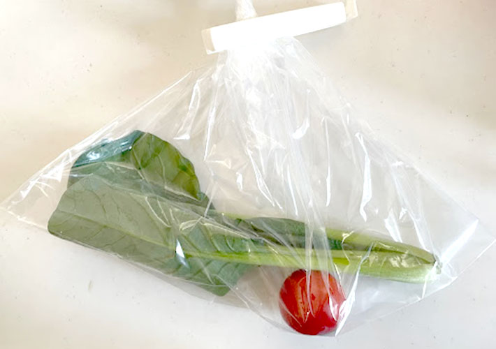 トマトと小松菜を『野菜や果物の鮮度を保つポリエチレン袋』に入れ保存クリップで封をした写真