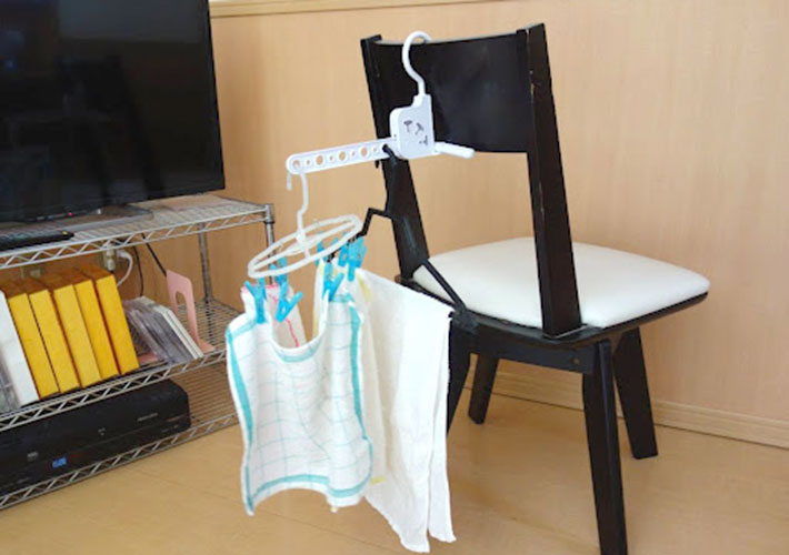 椅子の背に『室内干しハンガー（５連 角度調整可）』を引っ掛けてタオルを干している写真