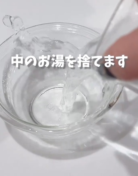 コップのお湯を捨てている様子