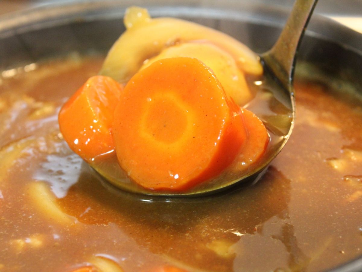 おたまでカレーをすくっている様子