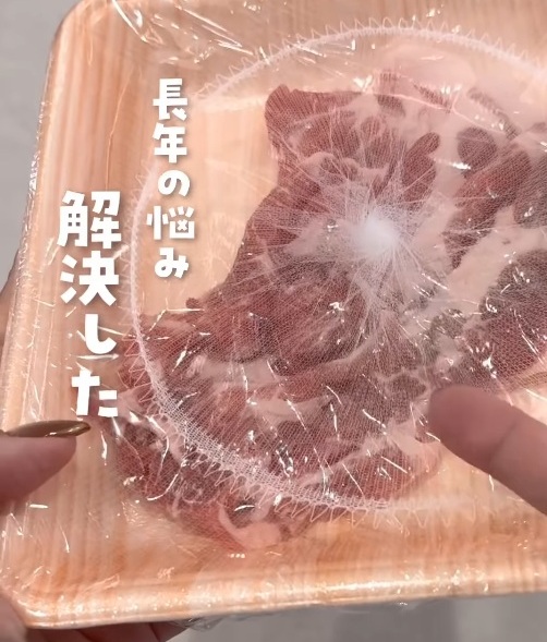 肉のトレーにラップと排水口ネットをかけている様子