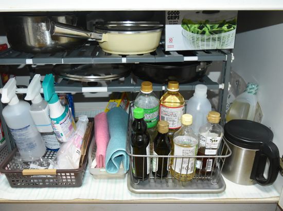 調理器具や調味料が収納されたキッチンシンク下の写真