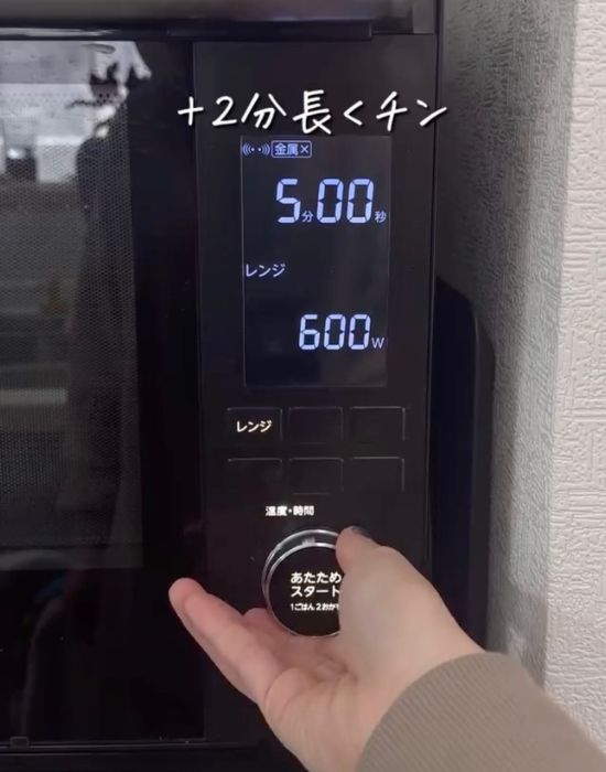 電子レンジの加熱時間を５分に設定する様子