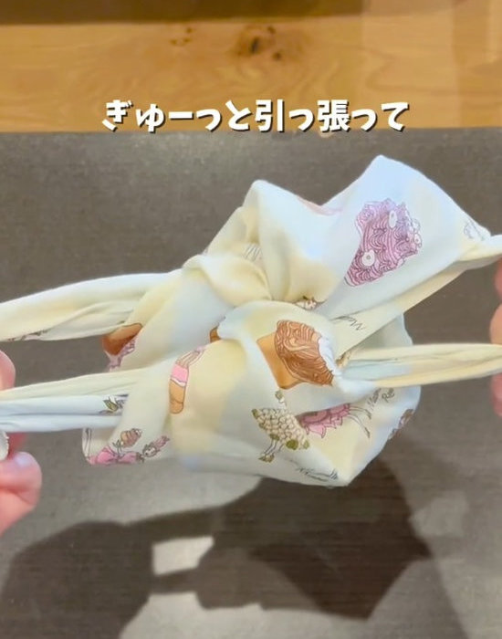 ハンカチの結び目を引っ張る様子