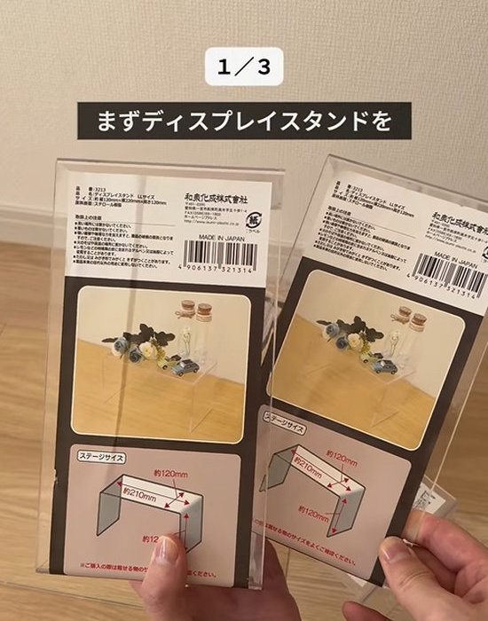ディスプレイスタンドを２つ手にしている様子