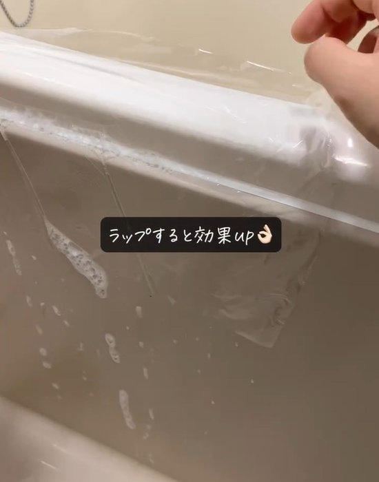 カビキラーを塗布した場所にラップを貼っている様子