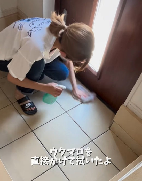 玄関タイルをタオルで拭いて掃除する様子