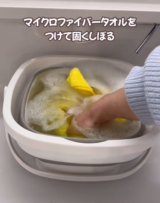 バケツにマイクロファイバータオルを入れている人
