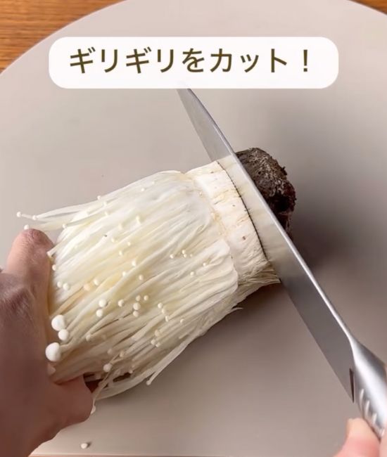 石づきの少し上に包丁を入れて切る様子