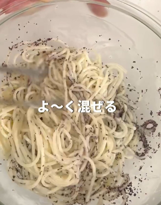 ボウルでパスタと調味料を混ぜる様子