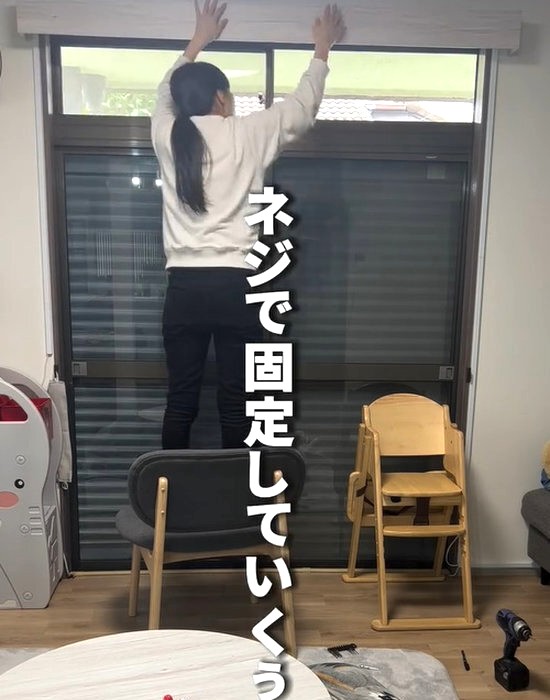 壁にカーテンボックスを設置する様子