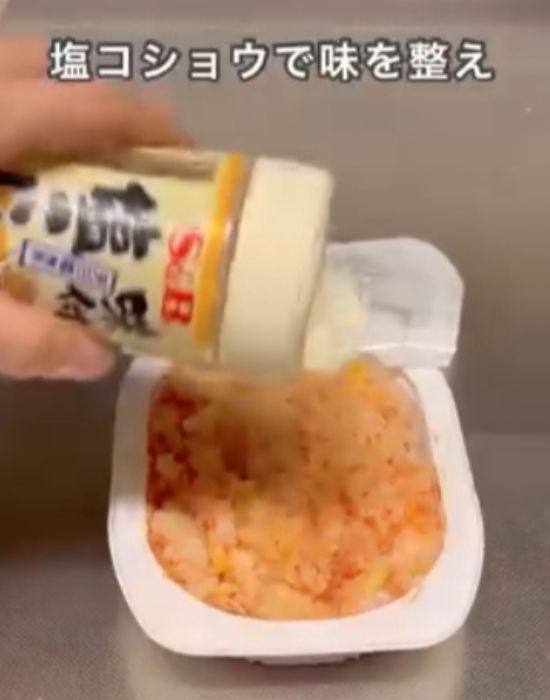 ケチャップを混ぜ合わせたパックご飯に塩コショウを振りかける様子