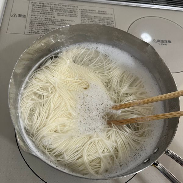 そうめんを鍋でゆがく様子