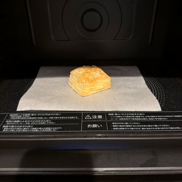 電子レンジ内でクッキングシートの上にパイを置いた状態