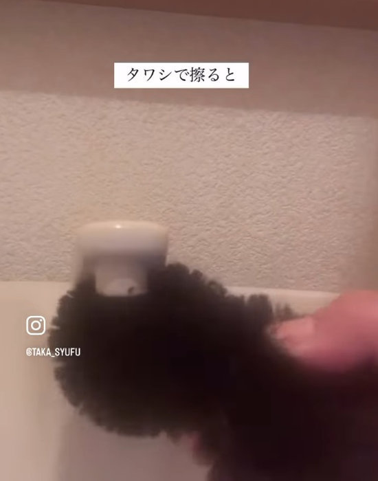 トイレの蛇口をタワシでこすっている様子