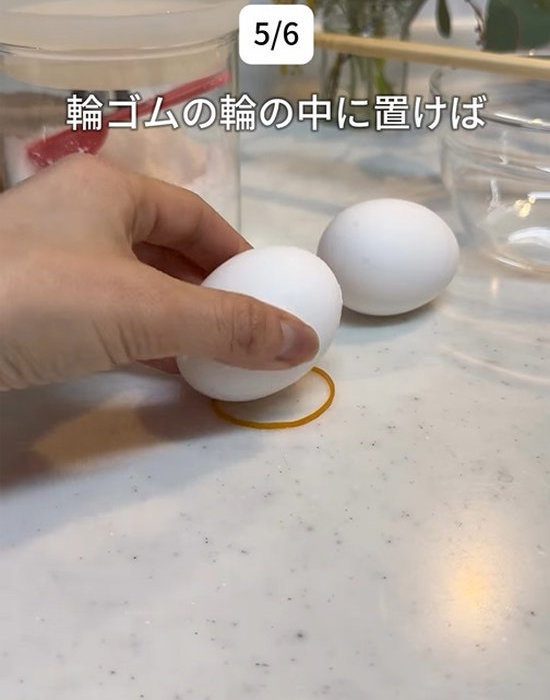 輪ゴムの輪の中に卵を置いている様子
