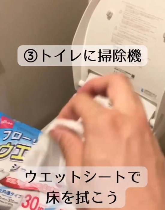 トイレの便座をトイレ用の掃除シートで拭く様子