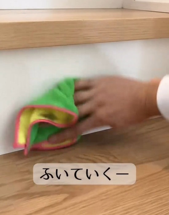 蹴込板を布で拭く様子