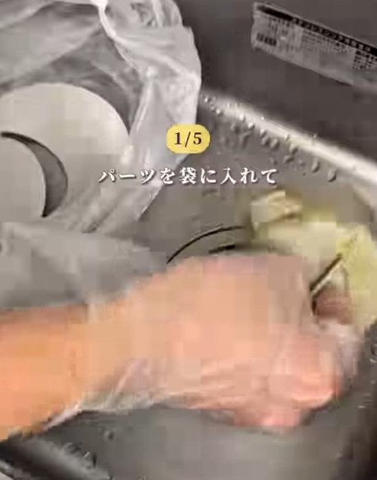 排水口のパーツをゴミ袋に入れている様子