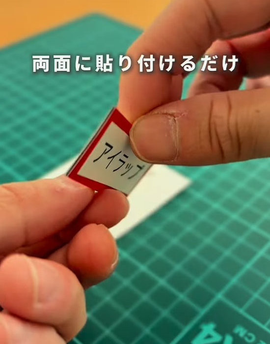 アイラップと書かれたマグネットシートを手にしている様子