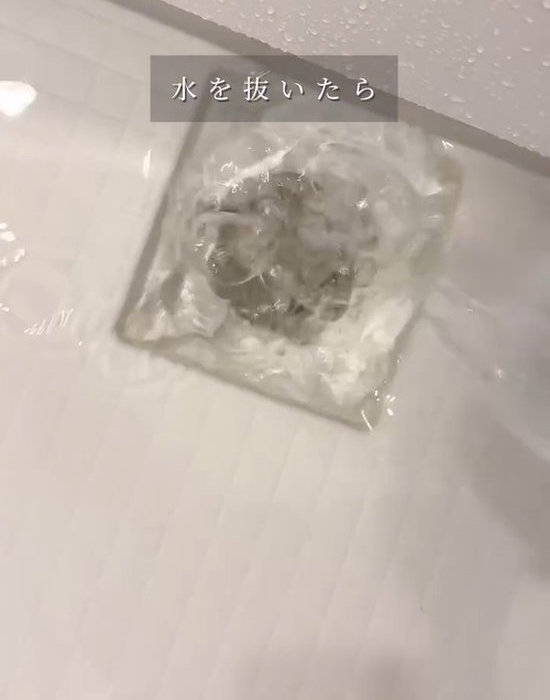 残り湯を排水溝へ流している様子