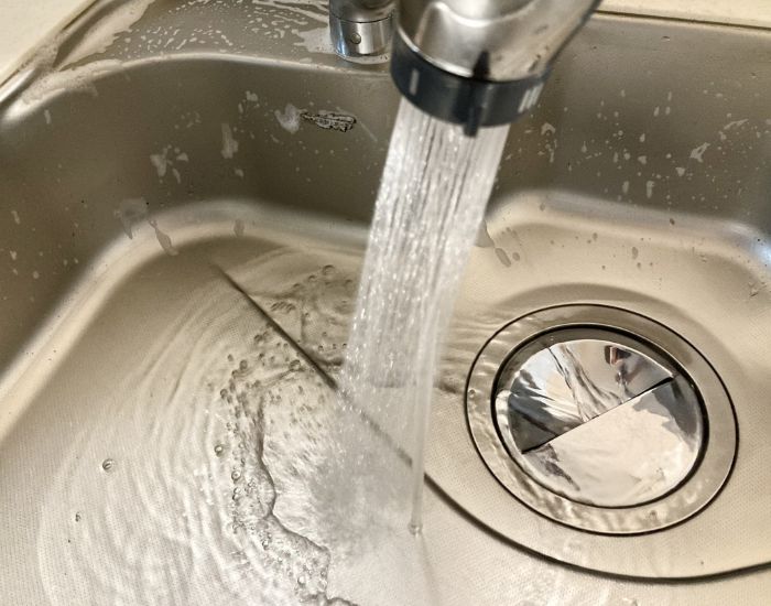 シンクに水道の水を流している様子