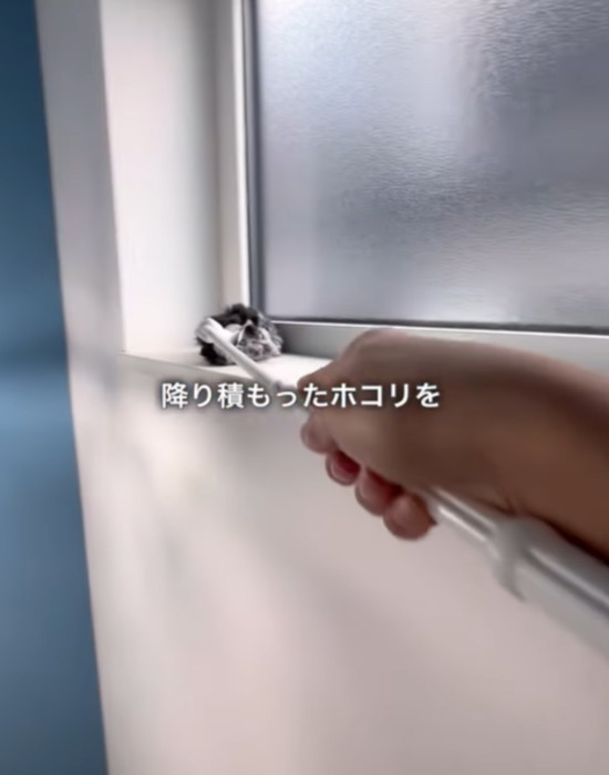 クイックルハンディでトイレの窓付近を掃除する様子