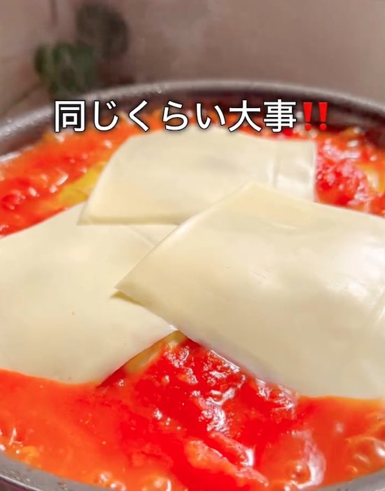 フライパンに入った具材にチーズをのせる様子