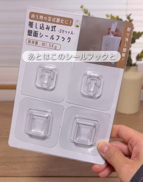 セリアの壁面シールフックを手にしている様子