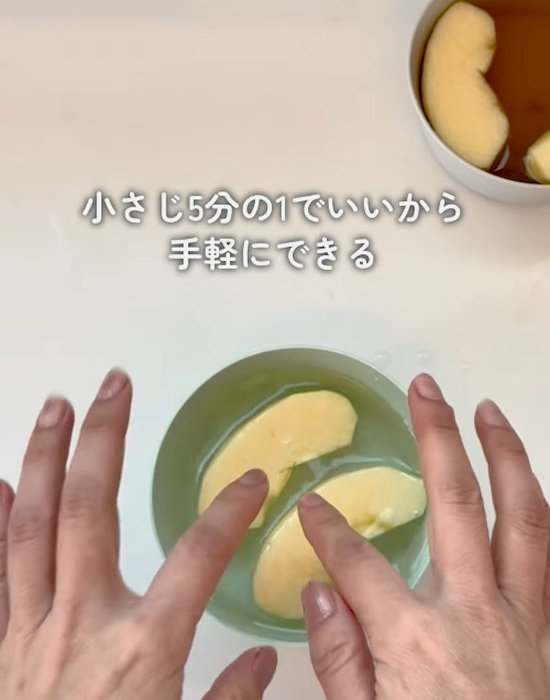 水が入った器の中にリンゴを入れる様子