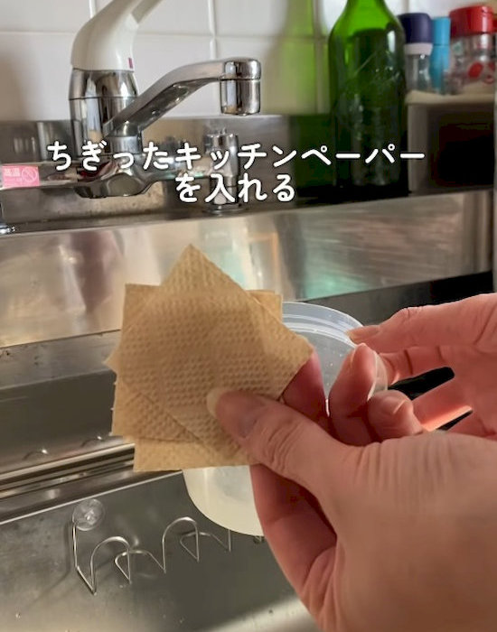 ちぎったキッチンペーパーを手にしている様子