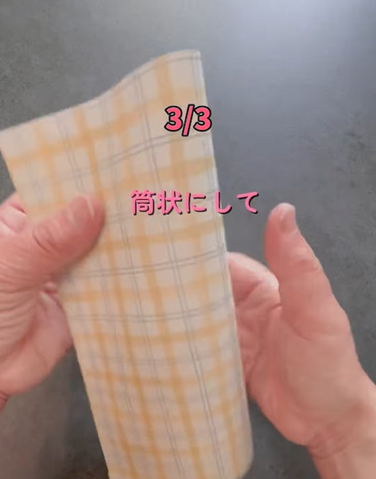A４サイズの紙を筒状にしている様子