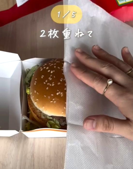 ハンバーガーに紙ナプキンをかぶせる様子