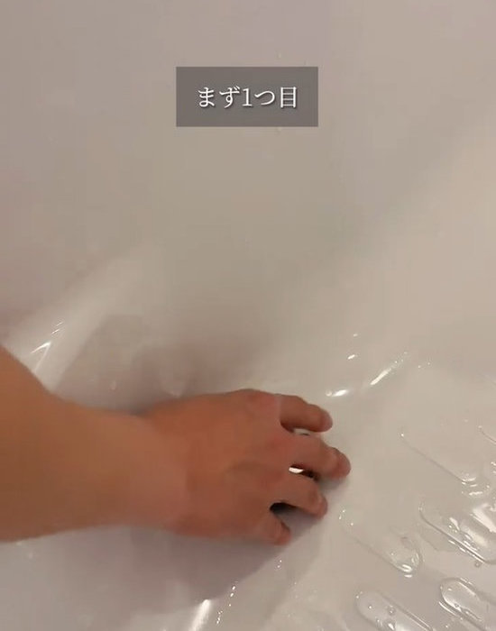 お風呂の排水栓に手をかける様子