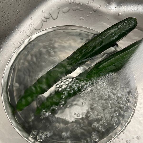 冷凍したキュウリに流水をあてる様子