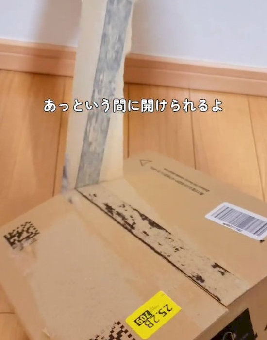 ダンボールのテープをはがしている様子
