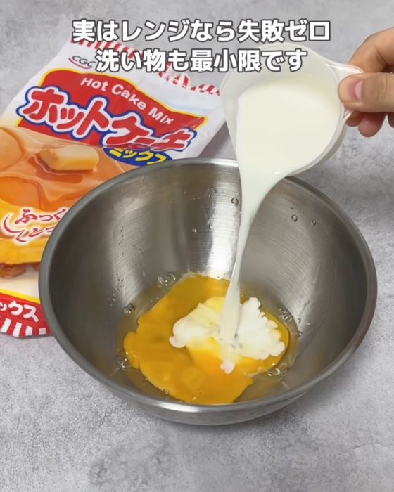 卵を割り入れたボウルに牛乳を入れる様子