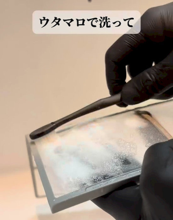 フィルターを歯ブラシで掃除している様子
