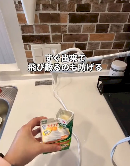 ホイップクリームのパックを手にしている様子