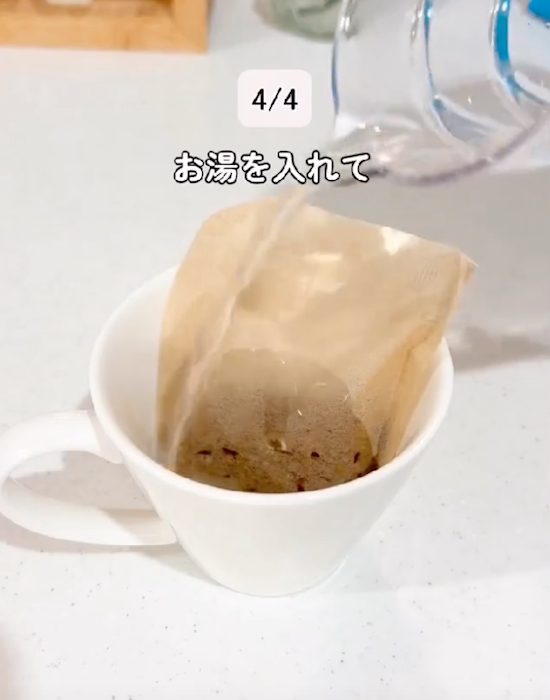 麦茶パックを入れたコップにお湯を入れる様子