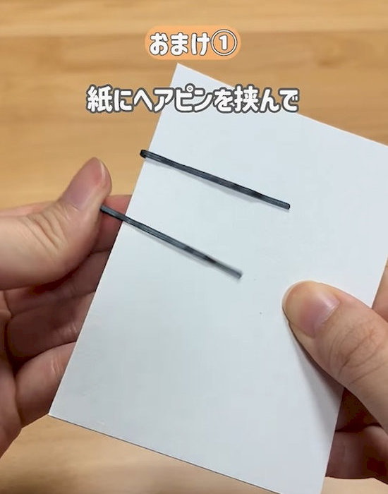 ヘアピンを紙に差し込んでいる様子